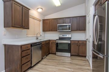 Herriman apartment for rent - A kitchen with wooden cabinets and stainless steel appliances.