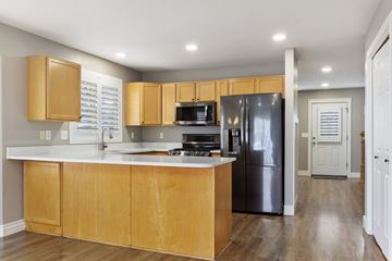 Layton apartment for rent - A kitchen with wooden cabinets and a black refrigerator.