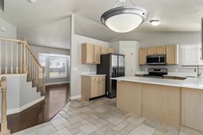 Layton apartment for rent - A kitchen with a refrigerator, microwave, and oven.