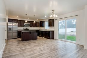 Saratoga Springs apartment for rent - A kitchen with dark wood cabinets and a center island.