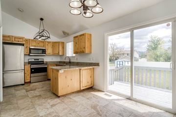 Clinton apartment for rent - A kitchen with wooden cabinets and a tiled floor.