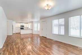 Layton apartment for rent - A spacious room with wooden floors and white walls.