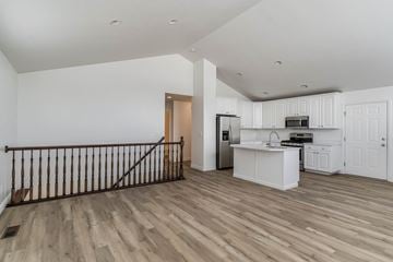 Layton apartment for rent - A kitchen with white cabinets and a wooden floor.
