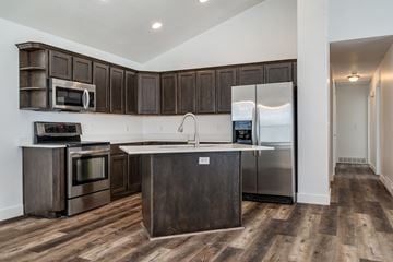 Clearfield apartment for rent - A kitchen with dark wood cabinets and stainless steel appliances.