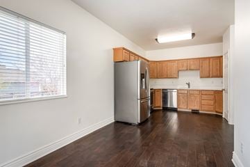 Saratoga Springs apartment for rent - A kitchen with wooden cabinets and a stainless steel refrigerator.