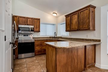 West Jordan apartment for rent - A kitchen with wooden cabinets and a granite countertop.