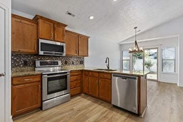 North Salt Lake apartment for rent - A kitchen with wooden cabinets and stainless steel appliances.