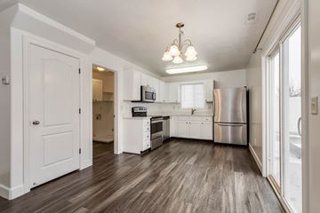 Saratoga Springs apartment for rent - A kitchen with white cabinets and a wooden floor.