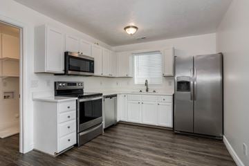 Saratoga Springs apartment for rent - A kitchen with white cabinets and stainless steel appliances.