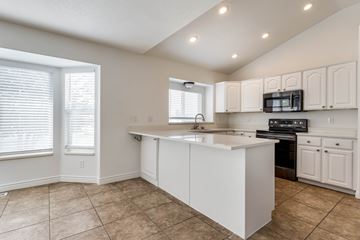 Clearfield apartment for rent - A kitchen with white cabinets and a large island.