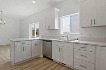 Eagle Mountain apartment for rent - A kitchen with white cabinets and a stainless steel dishwasher.