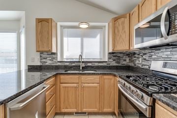 Clearfield apartment for rent - A kitchen with wooden cabinets and a black countertop.