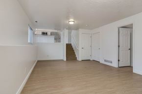 Lehi apartment for rent - an empty living room with white walls and wood flooring