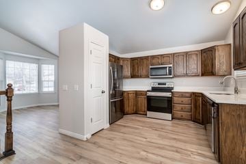 Clinton apartment for rent - A kitchen with wooden cabinets and a white refrigerator.