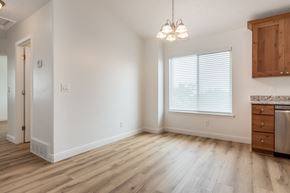 Eagle Mountain apartment for rent - an empty living room with wooden floors and a window