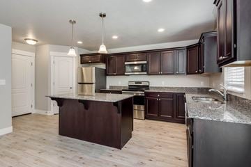 Saratoga Springs apartment for rent - A kitchen with dark brown cabinets and a granite countertop.