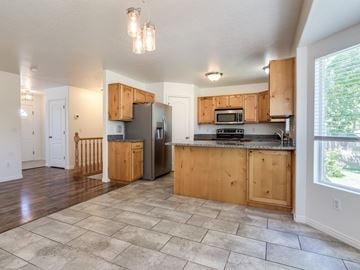 Syracuse apartment for rent - A kitchen with wooden cabinets and a tiled floor.