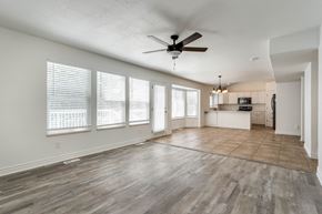 Clearfield apartment for rent - an empty living room with a ceiling fan and a kitchen