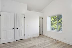 Lehi apartment for rent - an empty room with white walls and white doors and a window