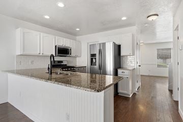 Clearfield apartment for rent - A kitchen with white cabinets and a granite countertop.