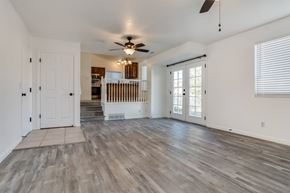 West Jordan apartment for rent - the living room of an empty house with a ceiling fan