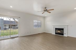 Kaysville apartment for rent - A spacious living room with a fireplace and sliding glass doors.