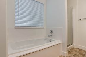 Saratoga Springs apartment for rent - A white bathtub with a window above it.