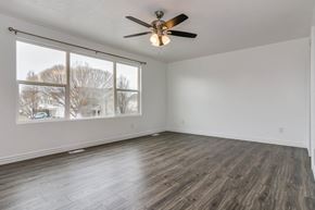 Saratoga Springs apartment for rent - an empty living room with a ceiling fan and a large window