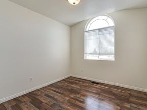 Syracuse apartment for rent - A room with a window and wooden flooring.