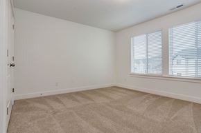 Saratoga Springs apartment for rent - the living room of an empty home with white walls and carpet