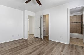 Layton apartment for rent - A room with a ceiling fan and wooden flooring.