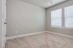 Saratoga Springs apartment for rent - an empty bedroom with two windows and a carpeted floor