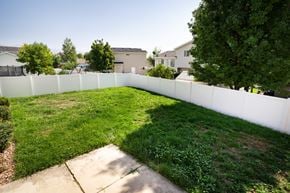 Clearfield apartment for rent - the backyard of a house with a white fence and grass