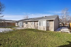 Provo apartment for rent - the back of a house with a yard and a fence