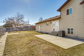 Roy apartment for rent - the back of a house with a patio and a yard