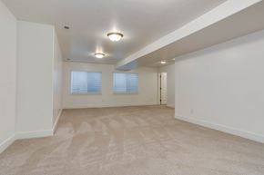 Saratoga Springs apartment for rent - A spacious room with carpeted floor and two windows.