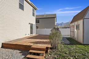 Spanish Fork apartment for rent - a backyard with a wooden deck next to a house