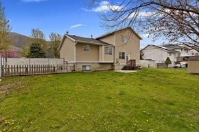 Centerville apartment for rent - a house with a yard and a fence in front of it