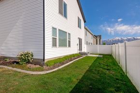 American Fork apartment for rent - A white house with a green lawn in front.