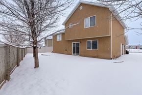 Spanish Fork apartment for rent - A house with a brown roof and a tree in front of it.