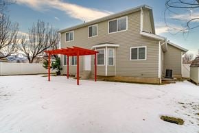 Layton apartment for rent - A house with a red pergola in the snow.