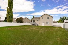 Clinton apartment for rent - A large house with a white fence and a green lawn.