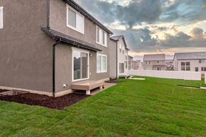 Saratoga Springs apartment for rent - a row of houses with a green lawn and a cloudy sky
