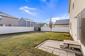 Spanish Fork apartment for rent - the back yard of a house with a fence and a lawn