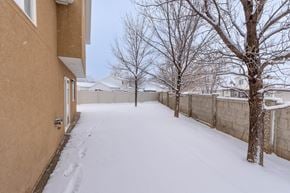 Spanish Fork apartment for rent - A snow-covered pathway between two buildings.