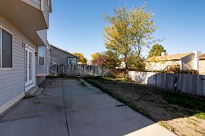 West Jordan apartment for rent - the backyard of a house with a sidewalk and a fence