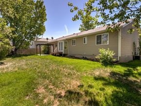 Syracuse apartment for rent - A house with a lawn and a tree in front of it.
