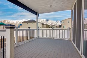 Stansbury Park apartment for rent - A deck with a railing and a view of houses and mountains in the background.