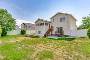 Woods Cross apartment for rent - A house with a white fence and a green lawn.