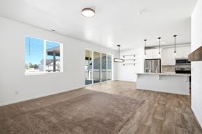 Stansbury Park apartment for rent - A spacious living room with a view of the street outside the window.